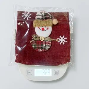 Detail of Christmas snowman wine bottle cover made of burlap showing the weight of 32.8 grams