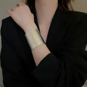Silver wide cuff bracelet with hammered metal texture and irregular crumpled design