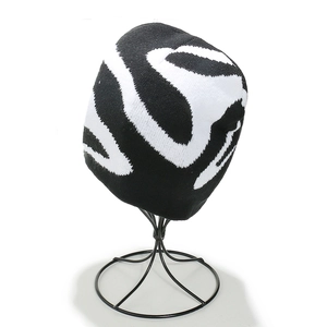Close-up of knit texture and black-and-white swirl pattern on the winter beanie