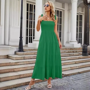 Elegant green tiered maxi sundress with thin straps shown in an outdoor street style