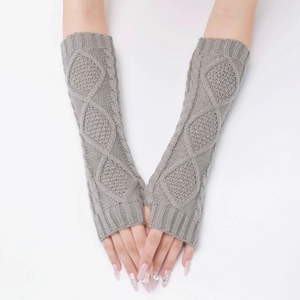 Detailed knit texture of grey arm warmers featuring a stylish braided cable pattern