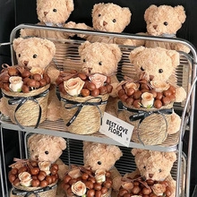 Shelf display of teddy bear gift sets with roses and woven baskets for flower shops