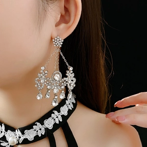 Detail of flower-shaped stud with crystal tassels and sparkling teardrop pendants
