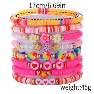 Detail of bohemian colorful bead bracelets set with heart and flower charms