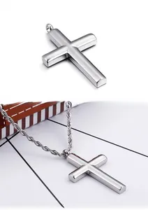 Close-up of polished silver cross pendant featuring a classic rope chain necklace