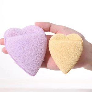 Detail of yellow and purple heart-shaped cleansing sponges with soft porous texture