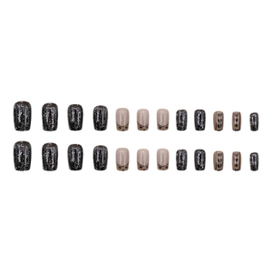 Sparkly black heart press-on nails with silver glitter and nude French patterns
