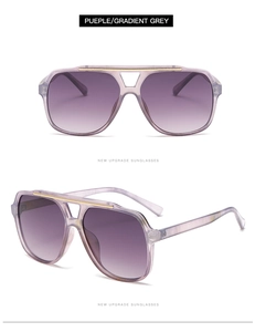 Detail of purple aviator sunglasses with gold top bar and gradient grey lenses