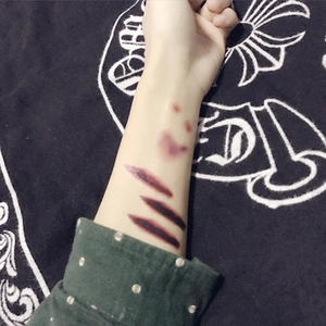 Waterproof Halloween temporary tattoo showing a realistic horror scar on an arm
