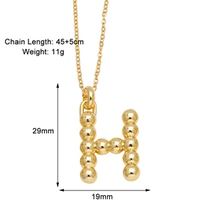 Detail view of a gold-plated bubble letter H pendant necklace with size dimensions