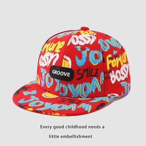 Detail of red kids hip hop cap with colorful graffiti patterns and GROOVE patch