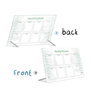 Macro view of clear acrylic weekly planner board with metal stand and notes section