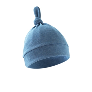 Detail view of a soft blue newborn knotted hat with a comfortable ribbed cuff