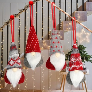 Detailed view of four red and grey knitted Christmas gnome hanging ornaments for holiday decor