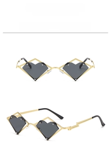 Detail of geometric heart sunglasses with gold metal frame and black lenses