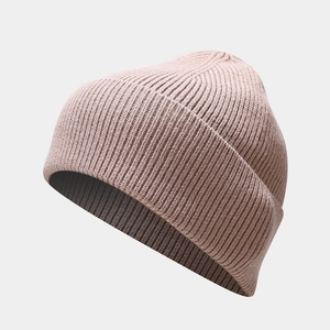 Detailed close-up showing the fine rib-knit texture of the pink winter beanie hat