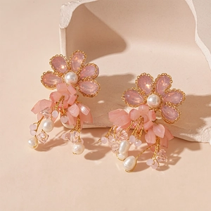 Detailed macro view of pink floral earrings with freshwater pearl tassels and gold plating