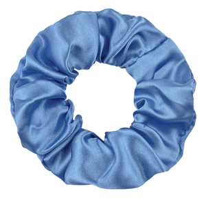 Detailed view of glossy blue satin fabric texture and pleated design on a hair scrunchie