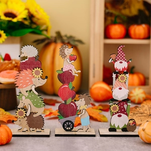 Detailed view of three tiered wooden autumn harvest gnomes and hedgehog figurines