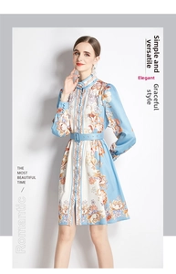 Detail of light blue floral printed A-line dress with buttons and matching waist belt
