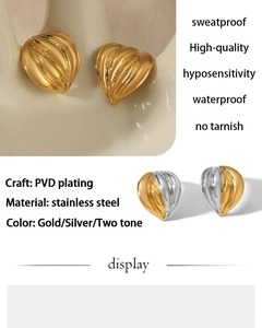 Detail of PVD gold plated stainless steel heart earrings with shell texture finish