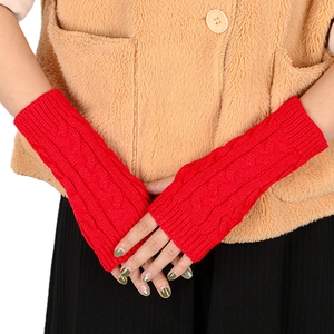 Close-up of red cable knit arm warmers showing detailed texture and fingerless design