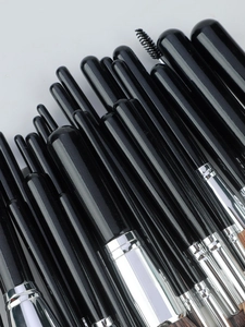 Detailed macro view of professional 30-piece makeup brush set with silver metal ferrules