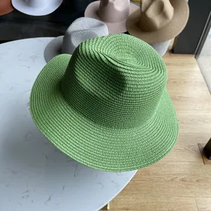 Detail of green straw fedora hat featuring a fine concentric woven texture for sun protection