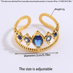 Detail view of a gold steel ring with five blue gems and adjustable size measurements