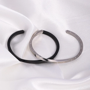Black and silver Mobius viking rune stainless steel cuff bracelets on white silk