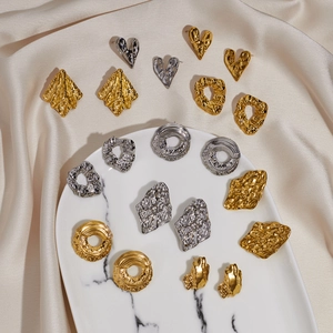 Irregular textured gold and silver metal earrings in heart and geometric shapes