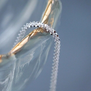 Macro shot of 925 sterling silver chain with detailed industrial texture on glass