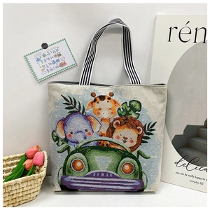 Close-up of beige canvas tote bag featuring colorful animal cartoon embroidery and striped handles