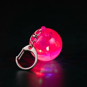 Close-up of a pink glowing disco ball keychain with LED light effect and metal clasp