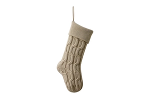 Close-up of beige knitted Christmas stocking with classic cable knit pattern and hanging loop