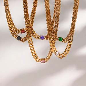 Detail view of 6.5mm gold Cuban chain necklaces with round colorful zircon stones