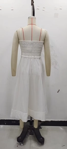 White cotton midi dress with elastic smocked back detail and flowing A-line silhouette