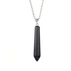 Macro detail of hexagonal black obsidian crystal pendant with polished silver chain
