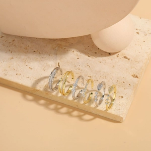 Macro shot of assorted gold and silver bow and floral rings on decorative stones