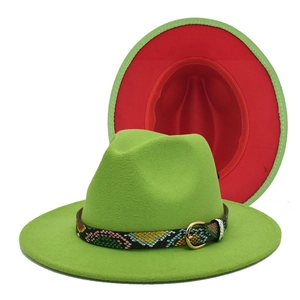 Detail of green fedora hat with red lining and colorful snakeskin pattern belt