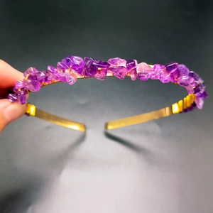 Close-up of handmade gold metal headband with irregular purple crystal stone chips
