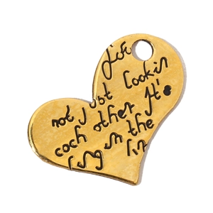Detailed view of a gold heart-shaped titanium steel pendant with engraved text