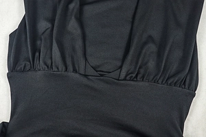 Close-up of ruched detail and satin texture on black sleeveless bodycon dress