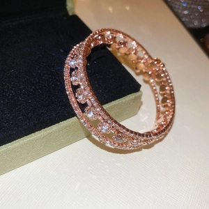 Detailed close-up of rose gold triple-layer open bangle with shimmering cubic zirconia