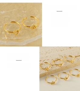 Close-up of adjustable stainless steel rings featuring cat paw, cloud and heart charms