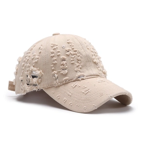 Distressed beige cotton baseball cap with ripped holes and worn-out streetwear style