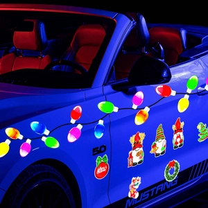 Close-up of colorful Christmas gnome and light bulb magnets on a blue car body