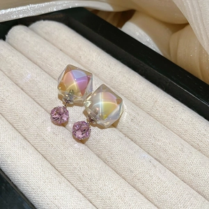 Close-up of aurora glass cube earrings with pink crystal ball on velvet jewelry box