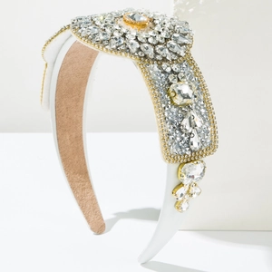Detail of luxury padded headband with white satin, amber centerpiece and sparkling crystals