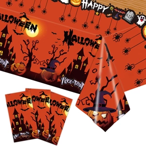 Detail of Halloween party set featuring orange tablecloth and bags with castle silhouettes